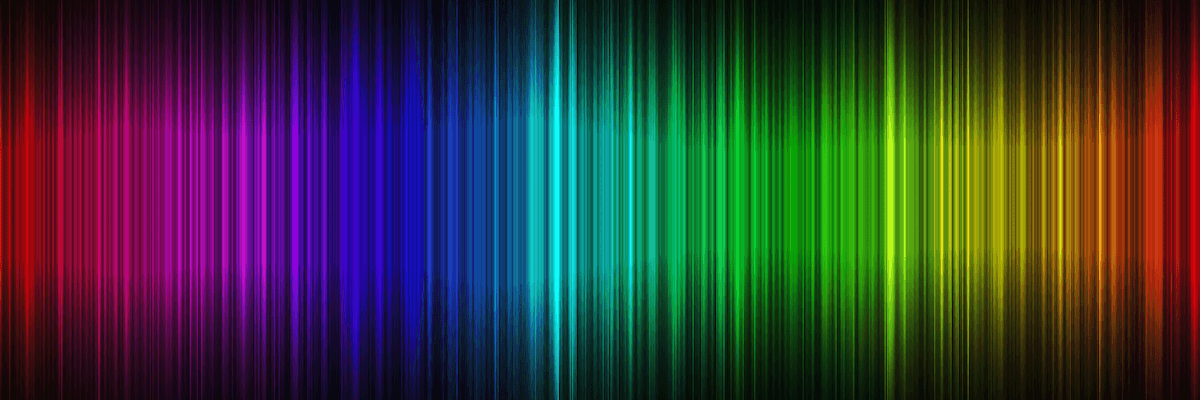 A waveform of the visible light spectrum from violet to red atop a black background