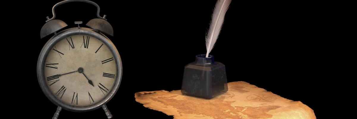 An analog alarm clock sits next to an ink well and quill pen atop some discolored parchment